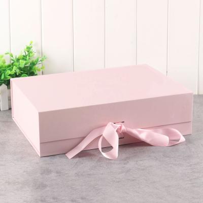 China Recyclable General Folding Clamshell With Hand Box Cosmetic Bow Tie Flat Fold Cardboard Gift Box for sale