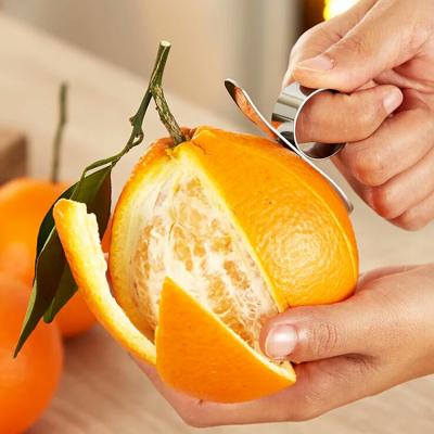 China Sustainable Stainless Steel Fruit Finger Protect Peeler Manual Orange Citrus Peeler for sale