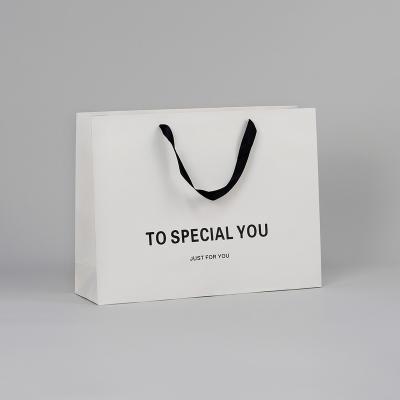 China Reused Materials Logo Environmental Paper Hand Bag Custom Made For Gifts for sale