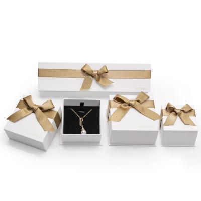 China Handmade Luxury White Jewelry Pendant Packaging Box With Gold Ribbon Logo Printed Custom Jewelry Boxes for sale