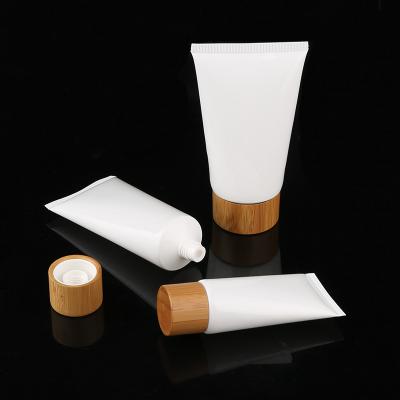 China wholesale empty 30ml plastic soft cosmetic tube, 60ml plastic white cream tube with bamboo cap, empty PET soft tube for sale