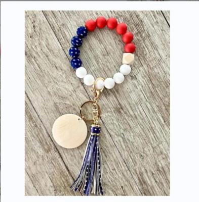 China Popular 2022 Latest July 4th Independence Day Wood beaded Wristlet Keychain Silicone Bead Bracelet Keychain Ring for sale