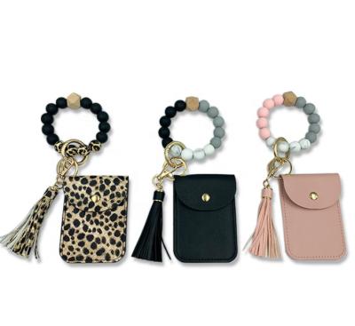 China Silicone Macrame Key Chain Bracelet Promotional Leopard Print Evil Eyes Wooden Bracelet Key Chain With Coin Purse for sale