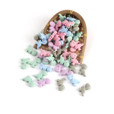 China DIY Food Grade Soft Wholesale Small Dinosaur Shaped Silicone Beads Food Grade Baby Teether Beads for sale