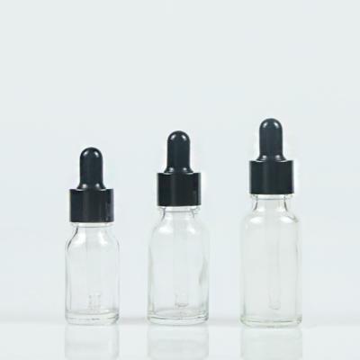 China Personal Care 10ml 20ml 30ml 50ml Cosmetic Dropper Packaging Clear Glass Bottle With Black Cap For Essential Oil Serum for sale