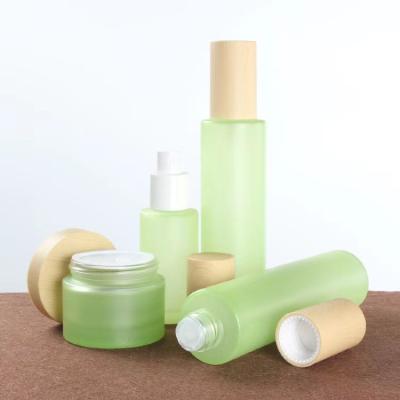 China Personal Care Skin Care Packaging Set Green Frosted Glass Facial Spray Lotion Bottle Cream Jar With Bamboo Top for sale