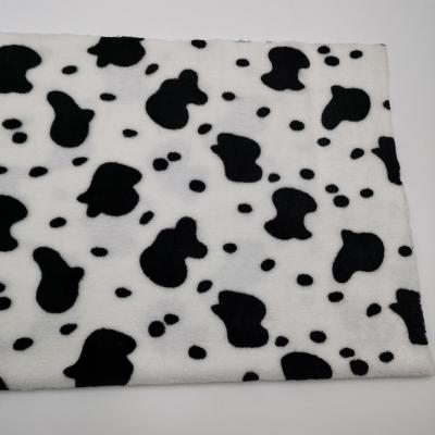 China Antistatic 100% Polyester PV Fleece Fabric Cow Printing Lightweight Fabric For Clothes And Toys for sale