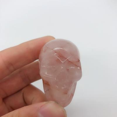 China Semi Previous Popular China Small Fire Bulk Skull Quartz Collectible Stones Crafts For Home Decoration for sale