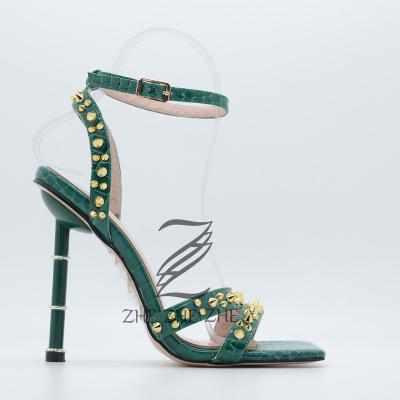 China 2022 fashion trend summer one word buckle strap vintage rivet sandals women's high heel snake print sandals new for sale