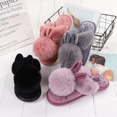 China Autumn and winter Anti-slippery non-slip warm bottom indoor women's lovely rabbit shoes cotton ball hair ear women's home slippers for sale