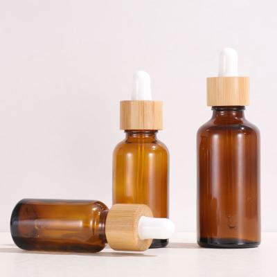 China 5ml 10ml 15ml 20ml 30ml 50ml 100ml Serum Bottle Amber Essential Oil Glass Dropper Cosmetic Bottle With Bamboo Lid for sale