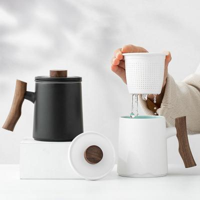 China Viable Unique Chinese Engravable Matte Black White Ceramic Tea Mug with Wooden Handle Infuser Lid for sale