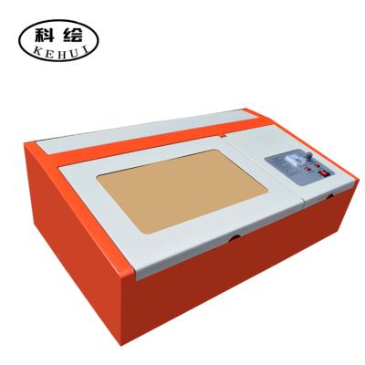 China Laser engraving latest 40W desktop cutting machine, mini CNC, CO2 laser engraving Liaocheng laser machine. for sale