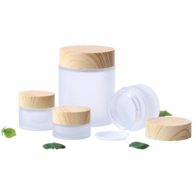 China Wholesale Cosmetic Cream Glass Jar Frosted Bamboo Cap Empty Cosmetic Jars 5g 10g 20g 50g for sale