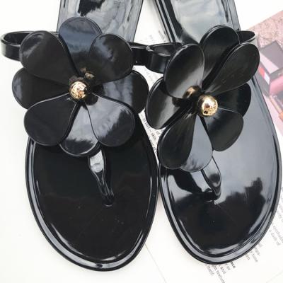 China Large Size 2022 Anti-slippery Women's Summer Black Flats Four-leaf Flower PVC Beach Lady Flip Flops Thin Shoes Jieyang Freeze Lovely TB Sandal for sale