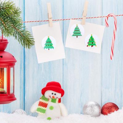 China 1inch Merry Christmas Sticker Festival Christmas Tree Pattern Creative Wholesale Heat Sensitive Gift Party Decoration for sale