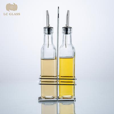 China Viable 500ml Olive Oil Vinegar Soy Sauce Glass Bottle Dispenser Set With Iron Stand for sale