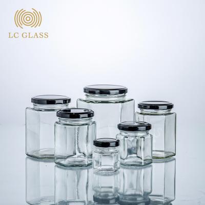 China Viable Wholesale Cheap Empty Food Honey Hexagon Glass Jar Storage For Canning With Lid for sale