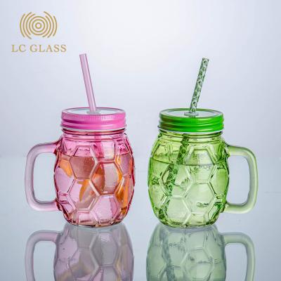 China Wholesale Beverage Football Shaped 450ml Empty Beverage Cup Clear Glass Mason Jar With Lids Handle And Straw for sale