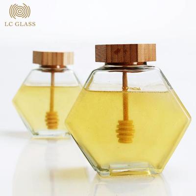 China Sustainable high quality luxury hexagon empty glass honey jar with bamboo lid and hexagonal honey jar glass for sale