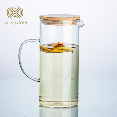 China Wholesale Sustainable Borosilicate Glass Juice Tea Water Bottle With Bamboo Lid And Glass Water Bottle for sale