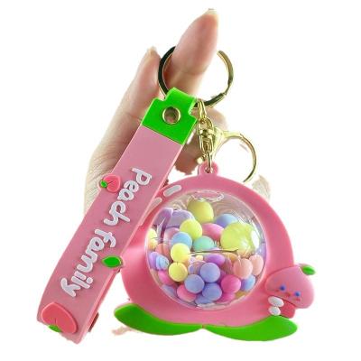 China Business gifts Creative Peach Family Quicksand into oil keychain claw machine small gift wholesale key chain for sale