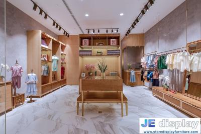 China Kids cloth store of interior design display furniture by wood color display cabinets and counters with leisure sofa chai for sale