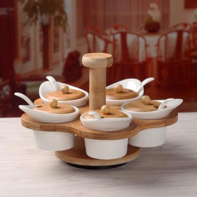 China Sustainable hot sale high quality ceramic seasoning jar with wooden base can be rotated for sale