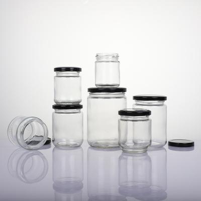 China Stocked Clear Glass Storage Jar OEM Salt Honey Bottle Airtight Wooden Lid for sale