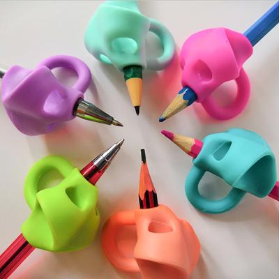 China Writing Exercise Pencil Holder for Kindergarten Students Writing Pen Cover Silicone Pencil Holder Pencil Corrector for sale