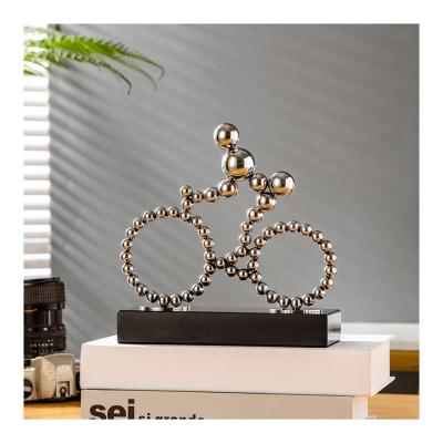 China Abstract Traditional Metal Bicycle Figure Statue Marble Ornaments For Living Room Simple And Luxury Study Interior Decoration for sale