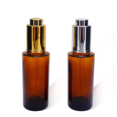 China 50ml cosmetic Amber Cylinder Glass Bottle with aluminum push button dropper for essence for sale