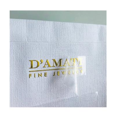 China Luxury Permanent Anywhere 3d Logo Embossed Waterproof Sticky UV Transfer Labels Gold Foil Metal Custom Stickers for sale