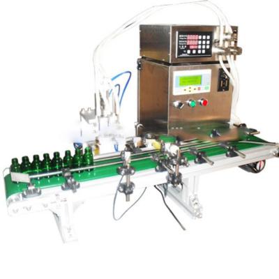 China Low cost 4 heads liquid filling machine mineral water alcohol glass water essential oil filling machine en venta