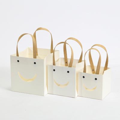 China Recycled Materials Flower Face Tote Bag Window Gift Bag Smile Transparent Packaging Bag for sale