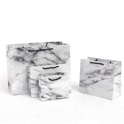 China Luxury Recyclable Recyclable Marble Ribbon Handle Shopping Paper Bag With Handle Marble Apparel Cosmetic Packaging Gift Bag for sale