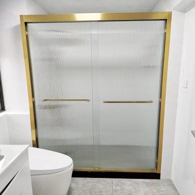 China Double Sliding Doors Foshan Brushed Golden Frame Shower Door With Grooved Glass for sale