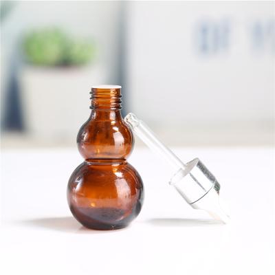 China Personal Care Gourd Shape Clear Essential Oil Amber Painting Glass Dropper Bottle Cosmetic Packaging Serum for sale