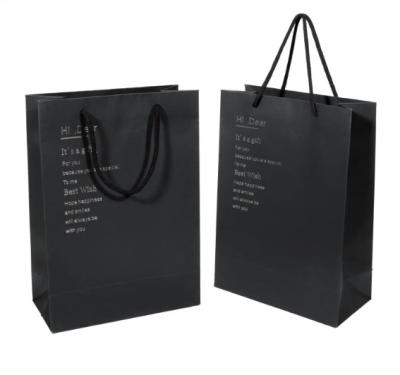 China Printed Black Cardboard Paper Gift Bag For Shopping Garment Packaging Custom Logo for sale