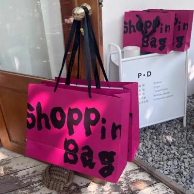 China Printed Retail Clothing Packaging Paper Bag Shopping Packaging Paper Bag for sale