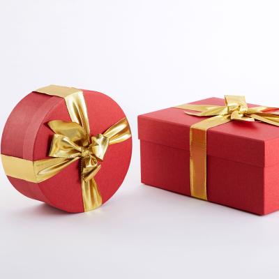 China Recycled Materials Custom Different Folded Red Cylinder Round Tube Packaging Gift Box With Ribbon for sale