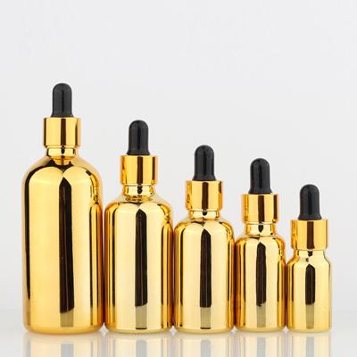 China Golden Brass Empty Glass Cosmetic Oil Bottles UV Electroplating For Essential Oils for sale