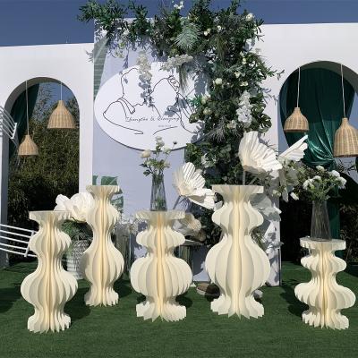 China Para wholesale bodas wedding event decoracion honeycomb white paper column cake foldable roman flower stand for rustic wedding decorations for sale