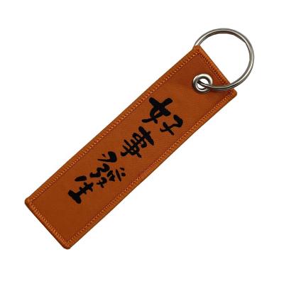 China Manufacture cheap custom brand keychains China embroidery logo fabric car motorcycle key chain custom keychains for sale