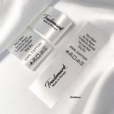 China Washable Custom White Satin Fabric Textile Label With Washing Instructions Laundry Care Label for sale