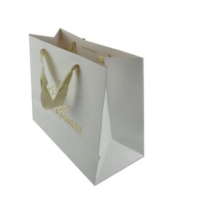 China New Golden Logo Hot Foiled Stamping Art Handmade Paper Bag With Ribbon Rope Handles Custom Gift Bags for sale