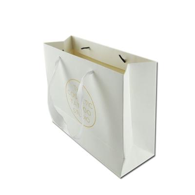 China Custom Recycled Materials Advertising Luxury Paper Bag With Ribbon Handles Logo Bag Hot Stamping Printed Paper for sale