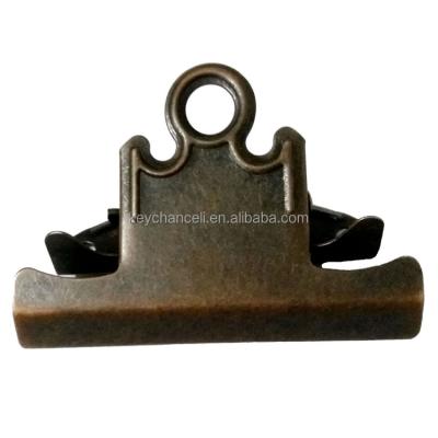 China Wood and Plastic Paperweight 78mm Rusted Reddish Bronze Age Cuts Bulldog Clip Metal Butterfly Paperweight Clip for Restaurant Menus for sale