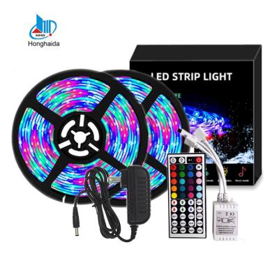 China Hot sale 10m 32.8ft flexible decoration smd 2835 rgb led strip lights come with power adapter and IR remote controller for sale