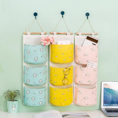 China Creative simple multi-function wardrobe storage bag storage bag minimalist triple imitation canvas triple hanging bag living room hanging bag for sale